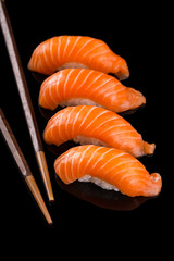 salmon nigiri sushi on the black background