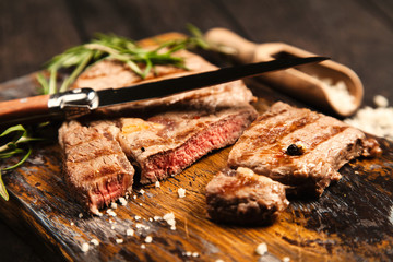 Grilled steak on wooden cutting board