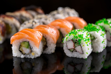 sushi rolls on the black background