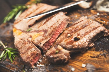 Grilled steak on wooden cutting board