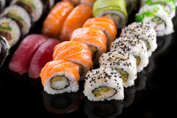 sushi rolls on the black background