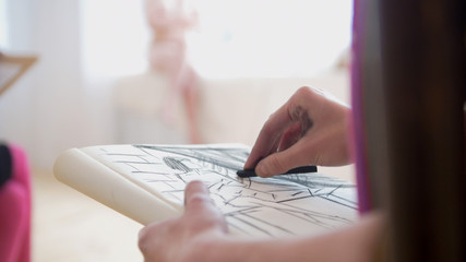 Nude female model in flont of woman painter draws sketches - blurred