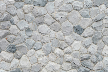 Closeup surface abstract at old stone wall in the garden textured background