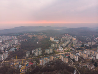 beautiful cityscape with sunrise. red sun rise above the mountains