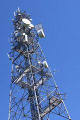  Telecommunication tower with antennas against the blue sky
