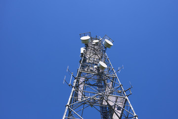  Telecommunication tower with antennas against the blue sky
