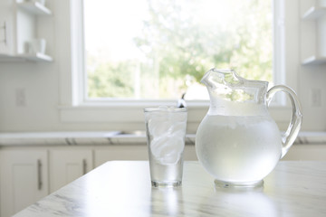 A pitcher and glass of ice water - obrazy, fototapety, plakaty