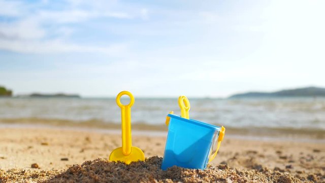 Toys on the sand beach with sea wave select focus shallow depth of field with summer atmosphere