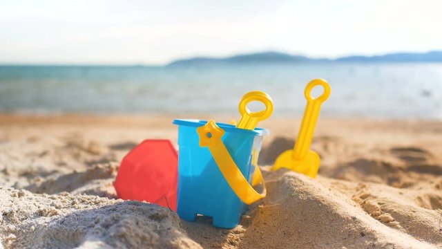 Toys on the sand beach with sea wave select focus shallow depth of field with summer atmosphere