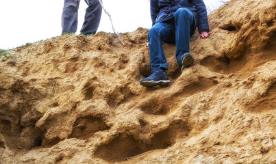 Man is preparing to descend from a sandy slope