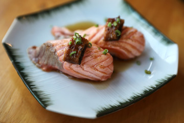 Grilled Salmon sushi on wood background