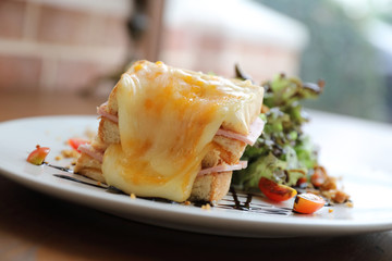 Ham cheese sandwich with salad on wood background
