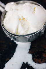 Fototapeta na wymiar Ice cream starting to melt in metal ice cream scoop.