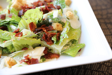 Caesar salad , vegetable with bread bacon and cheese