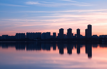 Fototapeta na wymiar Modern skyscrapers meeting sunset light rays background