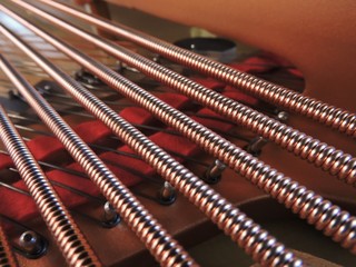 Strings inside a grand piano, closeup