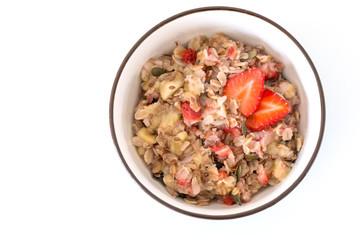 Bowl of healthy oatmeal with fresh strawberries for breakfast. Overhead shot.