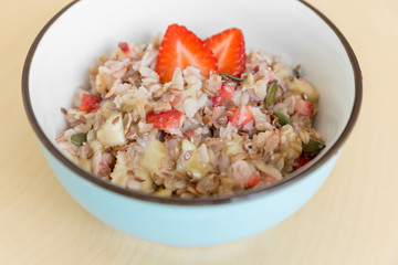 Bowl of healthy oatmeal with fresh strawberries for breakfast