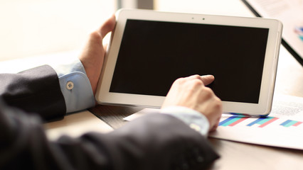 young businessmen using touchpad at meeting