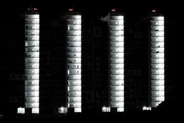 Night view of a new multi-storey residential building. Sleeping area.