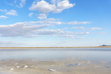 blue sky with clouds and distant mountains on the lake Baskunchak