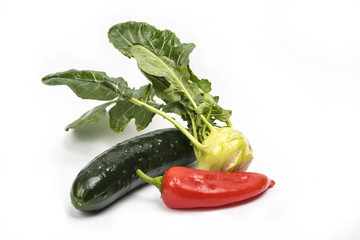 Various vegetables are isolated on a white surface