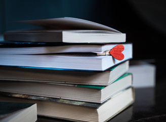 Books are close-up. A stack of books with a bookmark.