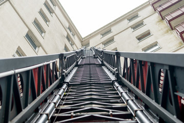 Looking up a Fireman Ladder, Firefighter Truck extendable Ladder next to Tower Block, England 2018 shallow depth of field horizontal perspective photography - 204280567
