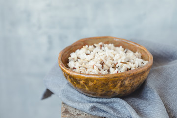 Bowl with wild brown mixed rice on the wooden background, wabi sabi style