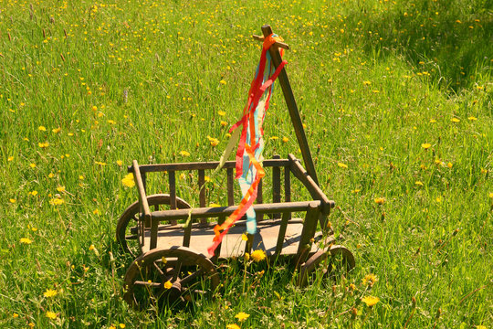 A handcart with a blanket, a beer box, colorful ribbons on a wonderful spring meadow for fathers day
