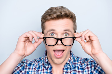 People reaction emotion expression person concept. Close up portrait of impressed funky handsome cute attractive green-eyed rejoicing manager freelancer touching glasses isolated on gray background