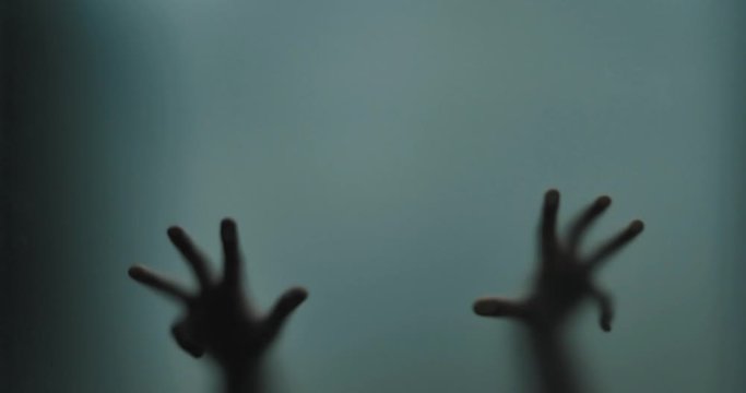 Shadowy figure behind glass / fear, panic concept