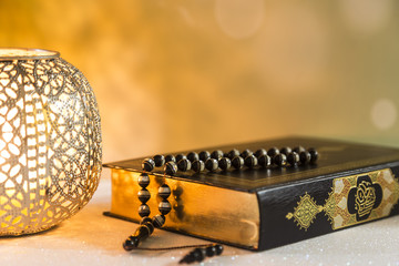 Koran - holy book of Muslims with lantern and rosary .ramadan concept.