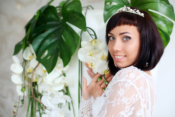 beautiful brunette bride in white lace peignoir