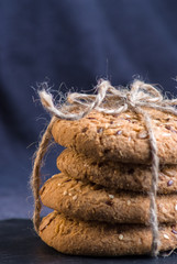 Savory cookies sprinkled with sesame seeds, sunflower on shale board