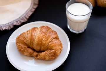 glass of milk with a croissant. Good breakfast