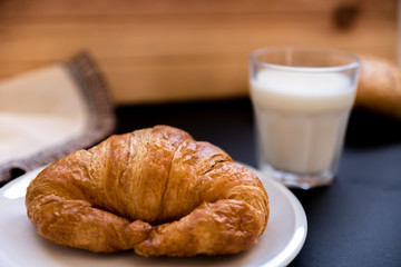 glass of milk with a croissant. Good breakfast