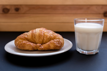 glass of milk with a croissant. Good breakfast