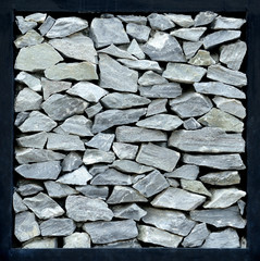 Gray stone wall with black steel frame.