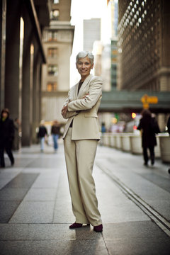 Portrait of a businesswoman standing on a city street and smiling.