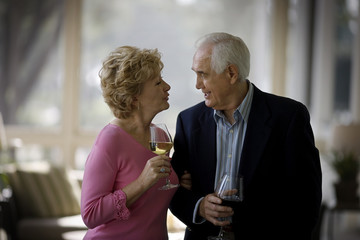 elderly couple drinking wine