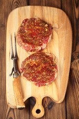 food meat - raw beef steak on wooden board