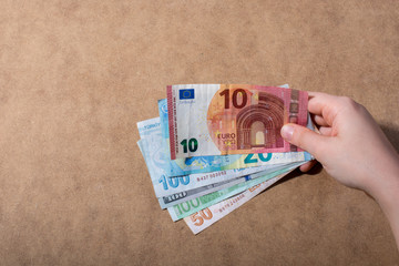 Hand holding American dollar  isolated on wooden background