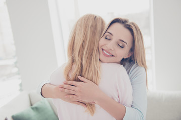 Obraz na płótnie Canvas Portrait of cute charming lovely beloved sweet girl enjoying warm hugs with her mother keeping eyes closed having pleasure, my soul heart love you forever