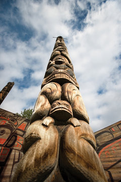 Low angle view of totem pole against cloudy sky