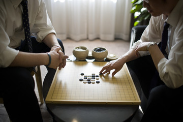 Board game being played by two businessmen.