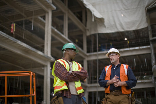 Two builders talking on a construction site