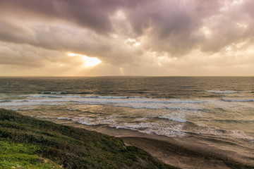 Sun hides behind the cloud on the sardinian coast