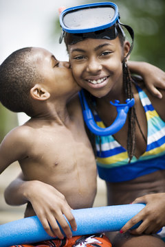 Boy giving his sister a kiss on the cheek