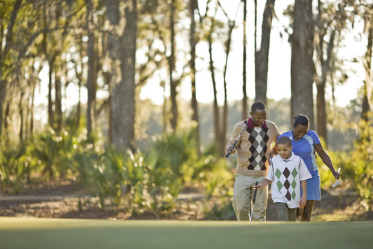 Family walking across golf course
